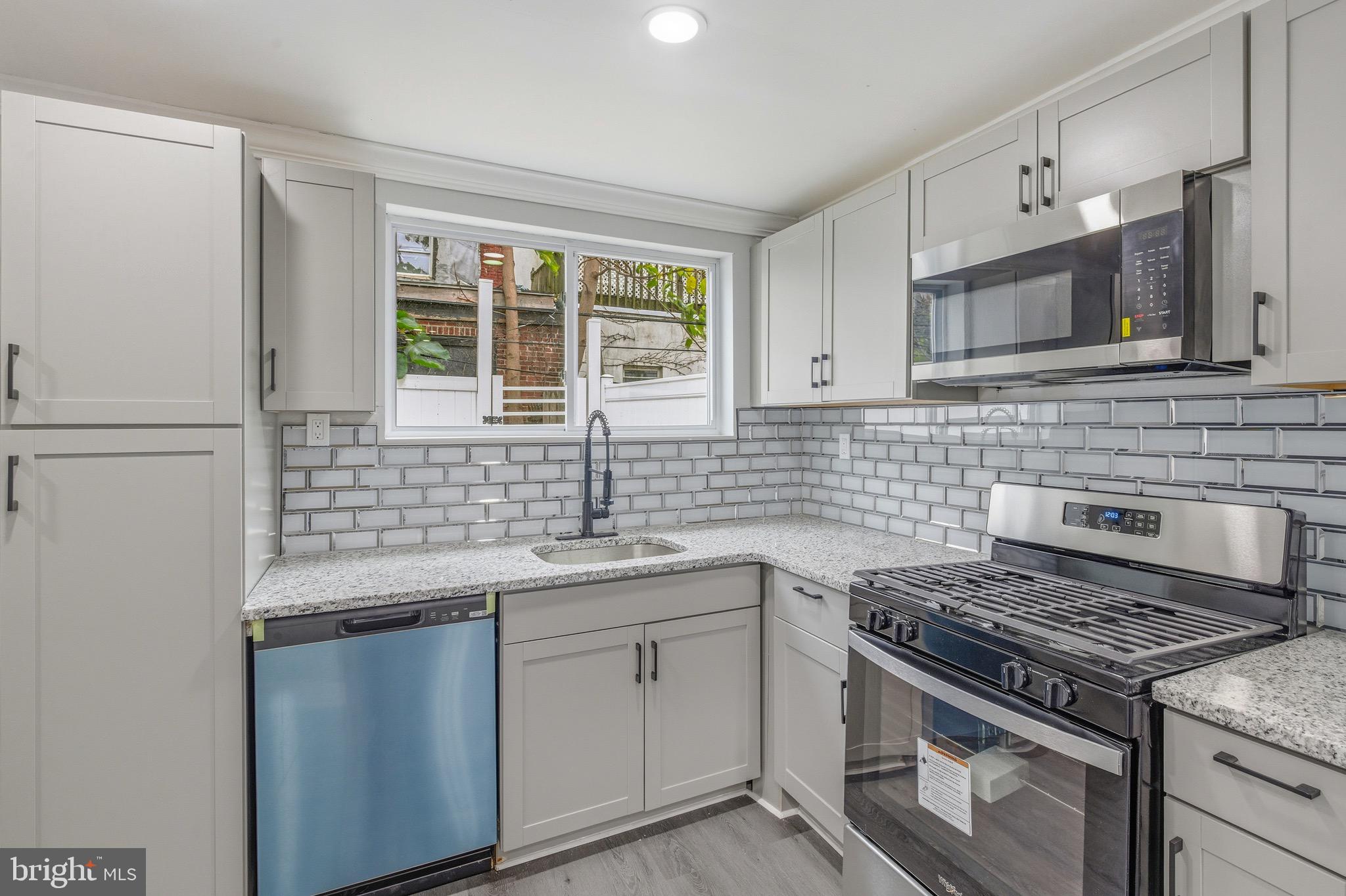 625 Cantrell Street Philadelphia, PA 19148 - Photo 4 of 15 a kitchen with stainless steel appliances granite countertop a sink stove and cabinets