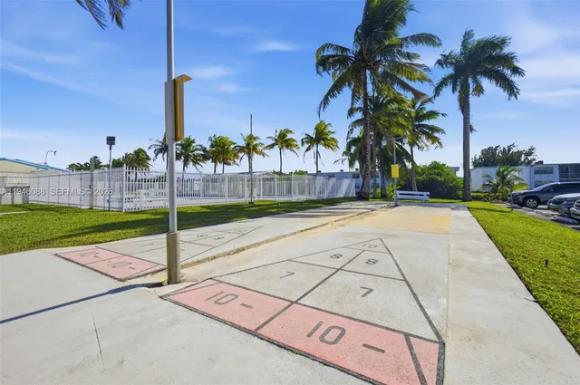 a front view of a house with garden and trees