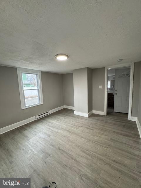110 Milburn Street Elkton, MD 21921 - Photo 2 of 7 an empty room with wooden floor and windows