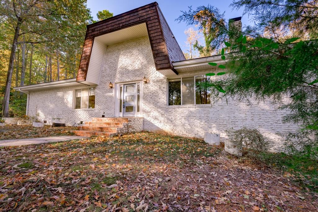 675 Willeo Road Roswell, GA 30075 - Photo 1 of 1 Unique weeping mortar design, eclectic architecture, solid 4-sided brick home with massive carport