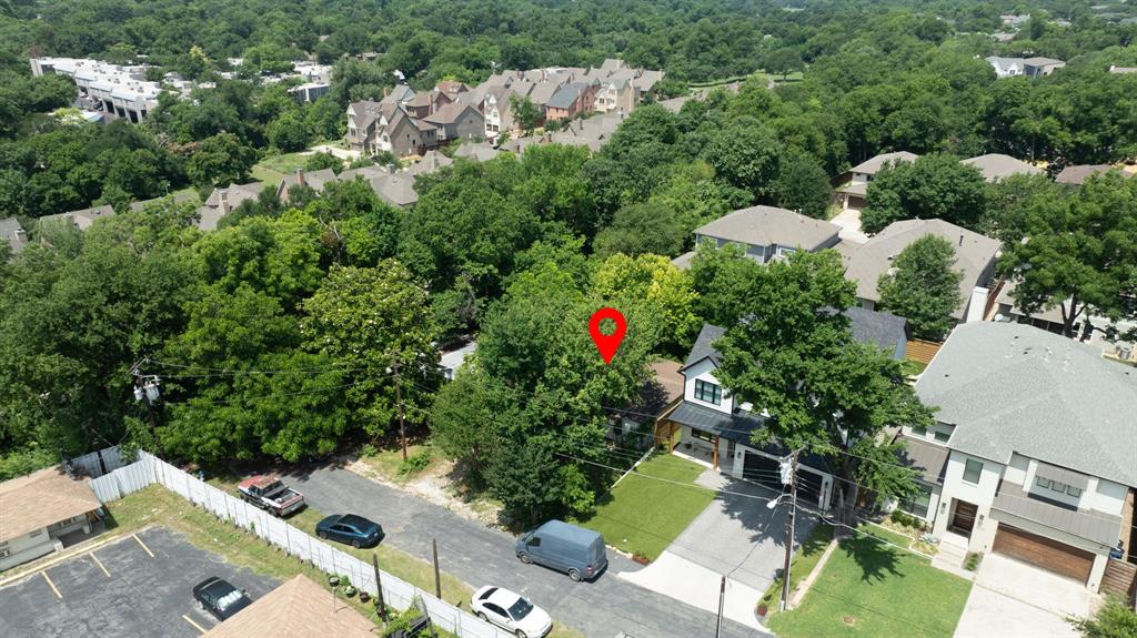 an aerial view of residential house with outdoor space and trees all around