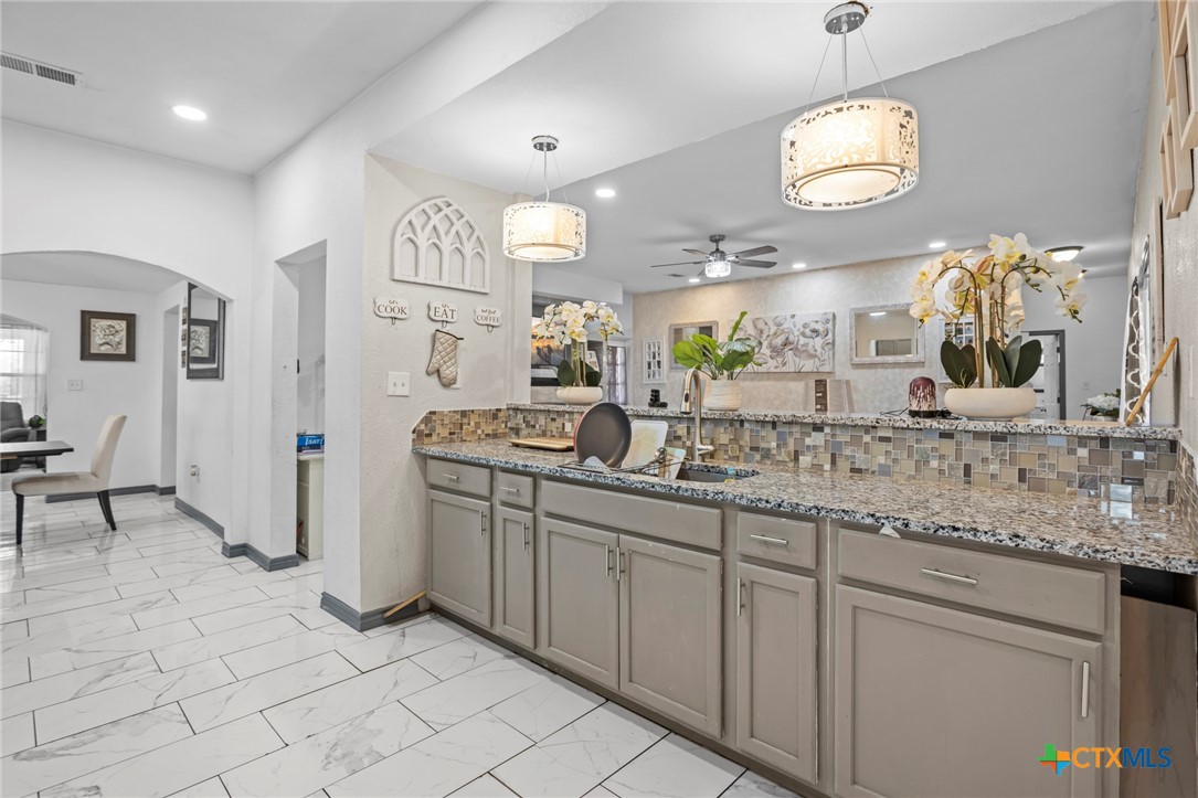 811 Ward Street Marlin, TX 76661 - Photo 11 of 31 an open kitchen with a sink and dishwasher with kitchen view