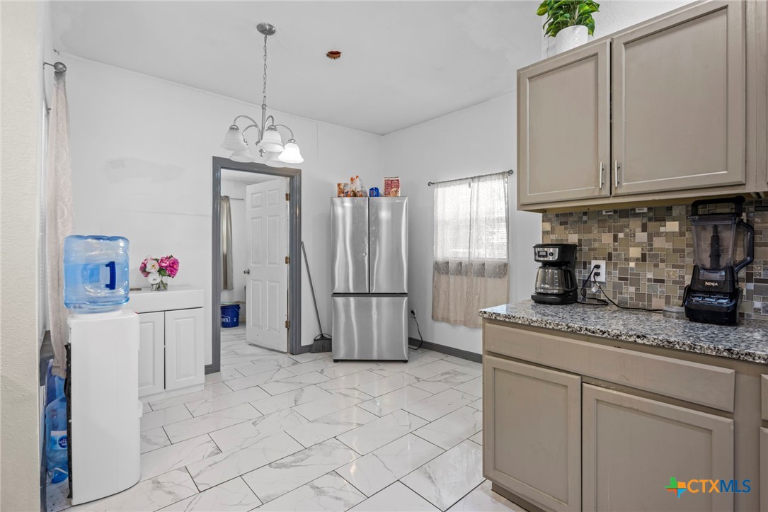 811 Ward Street Marlin, TX 76661 - Photo 12 of 31 a kitchen with refrigerator and cabinets