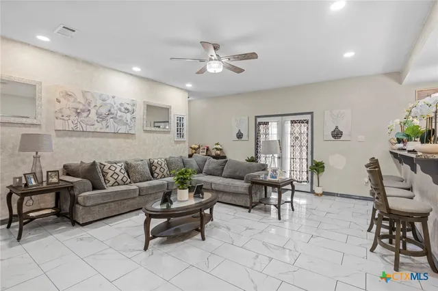a living room with furniture and a chandelier