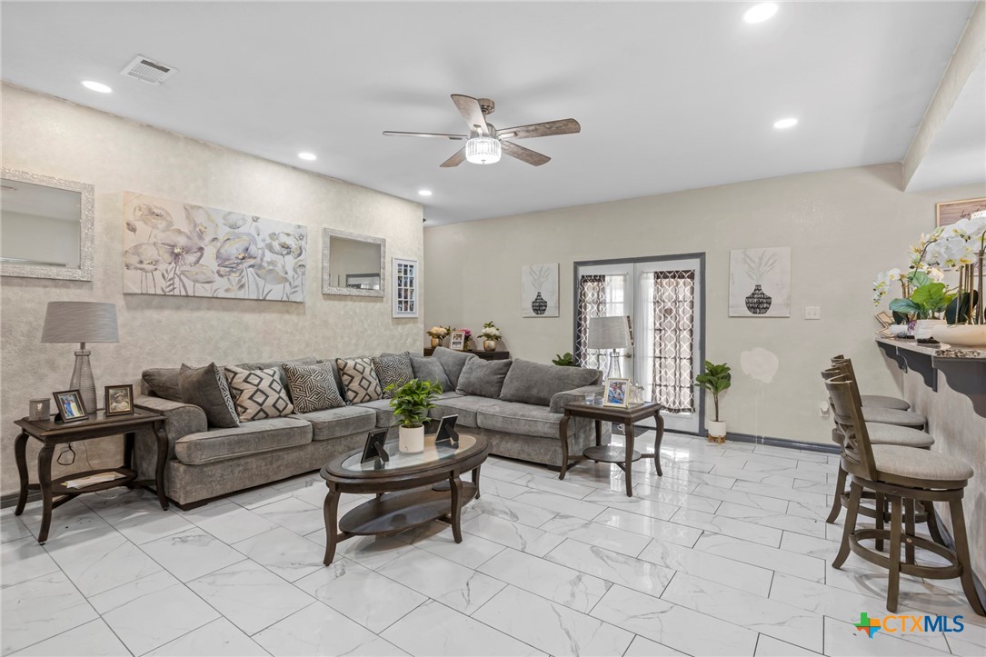 811 Ward Street Marlin, TX 76661 - Photo 15 of 31 a living room with furniture and a chandelier