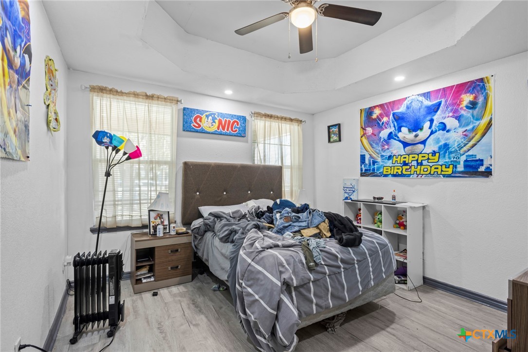 811 Ward Street Marlin, TX 76661 - Photo 18 of 31 a bedroom with a bed and a chandelier