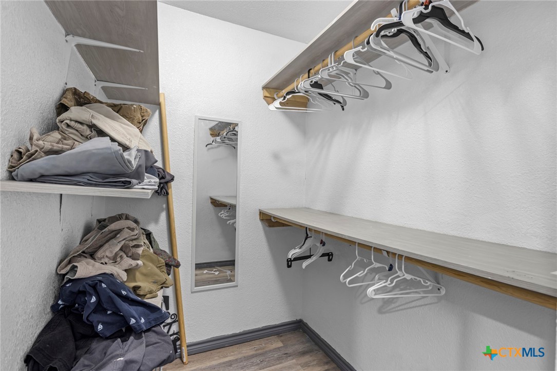 811 Ward Street Marlin, TX 76661 - Photo 24 of 31 a view of walk in closet with clothes and shoes