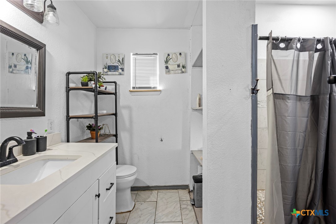 811 Ward Street Marlin, TX 76661 - Photo 25 of 31 a bathroom with a sink toilet and shower