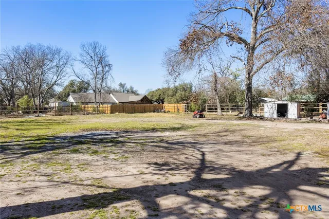 a view of a yard with swimming pool and an outdoor space