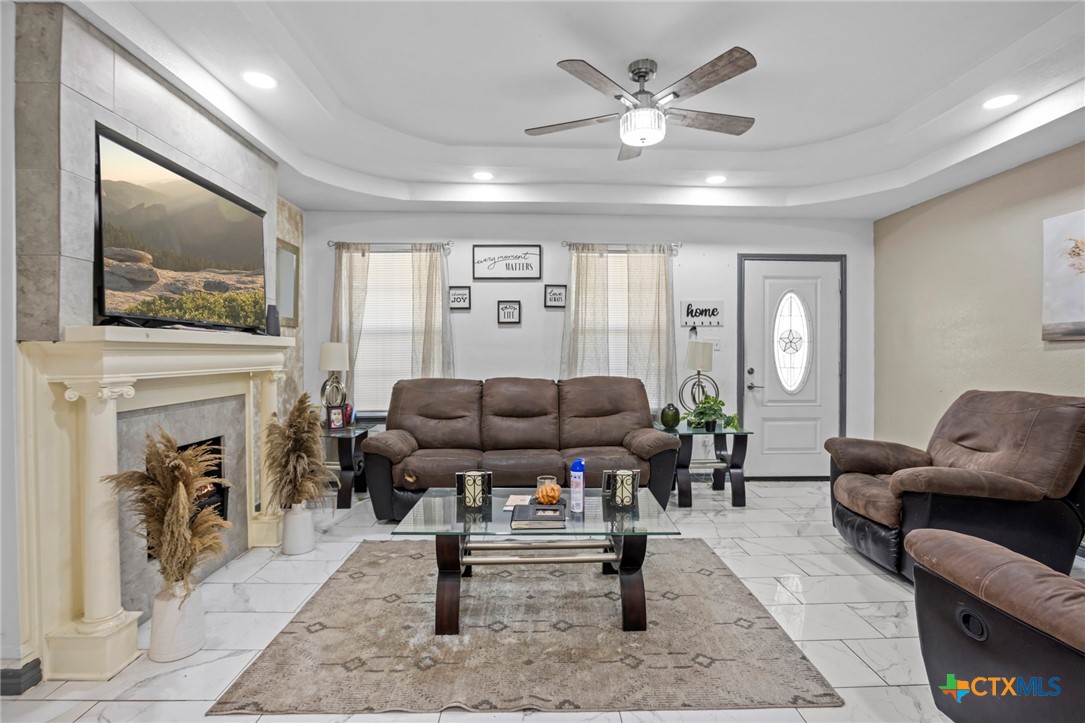 811 Ward Street Marlin, TX 76661 - Photo 5 of 31 a living room with furniture a fireplace and a flat screen tv