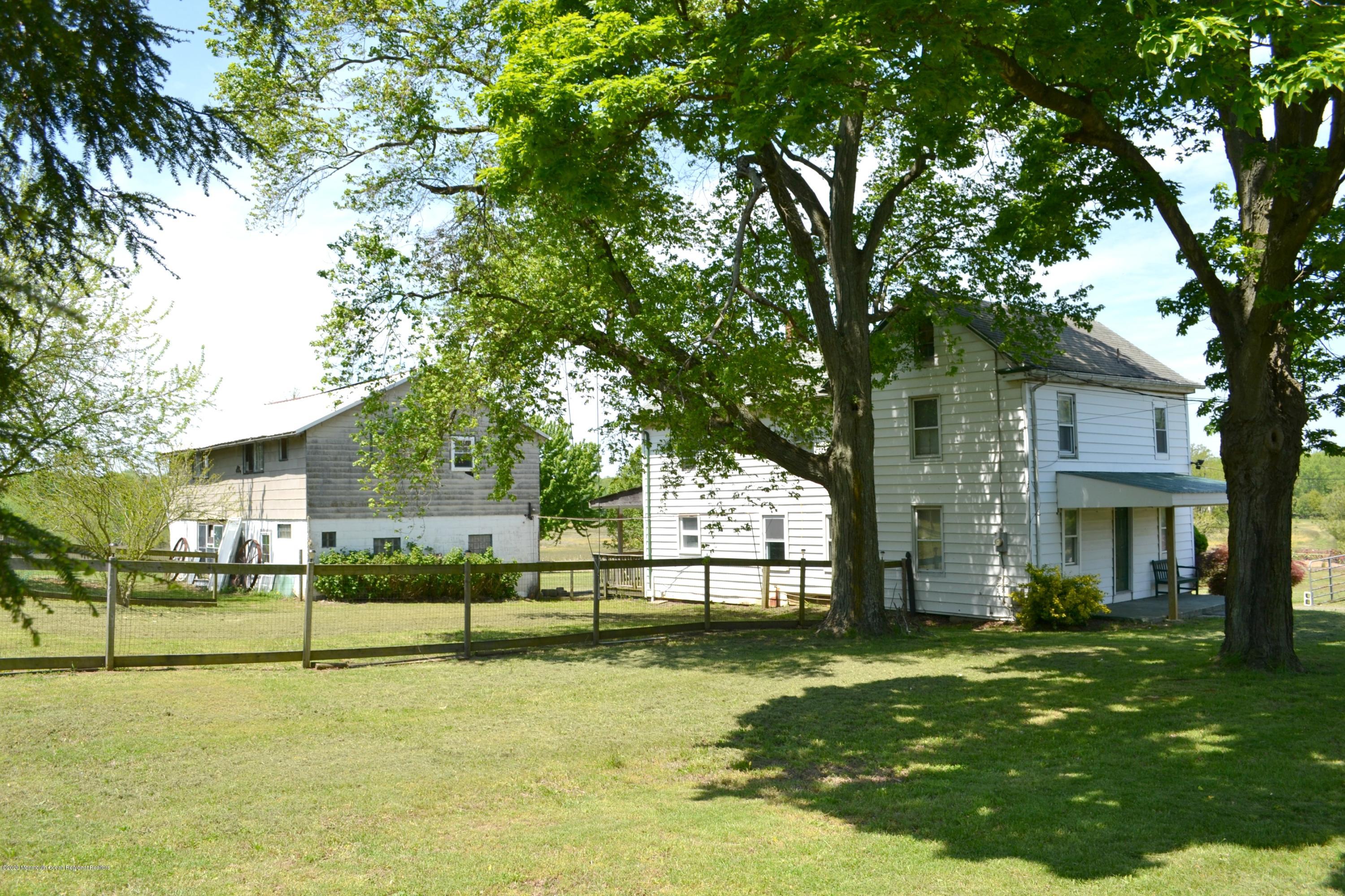 1167 Hedding Road Columbus, NJ 08022 - Photo 1 of 16 a view of a white house next to a yard with a large tree
