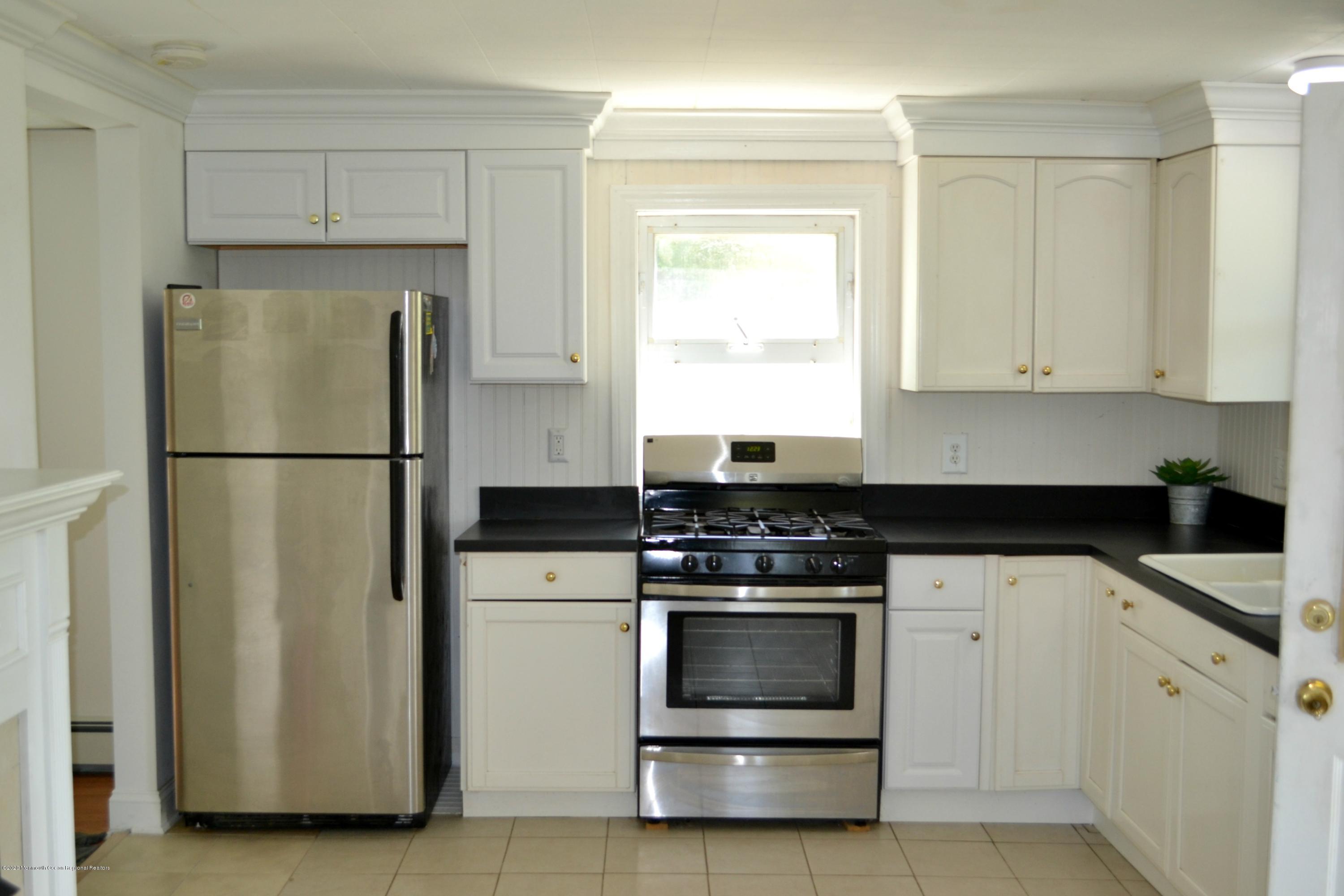 1167 Hedding Road Columbus, NJ 08022 - Photo 3 of 16 a kitchen with white cabinets and stainless steel appliances