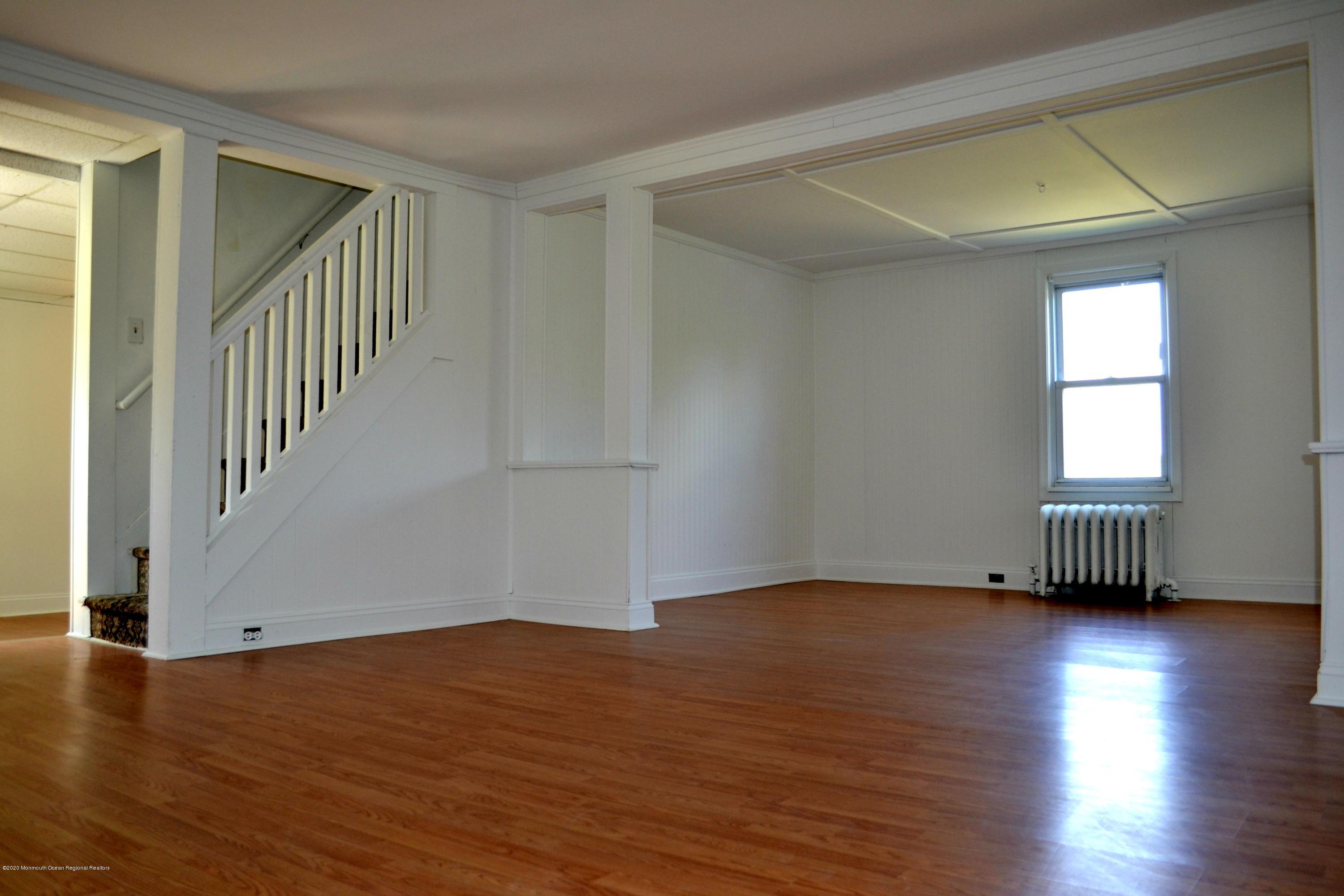 1167 Hedding Road Columbus, NJ 08022 - Photo 4 of 16 a view of an empty room with wooden floor and a window
