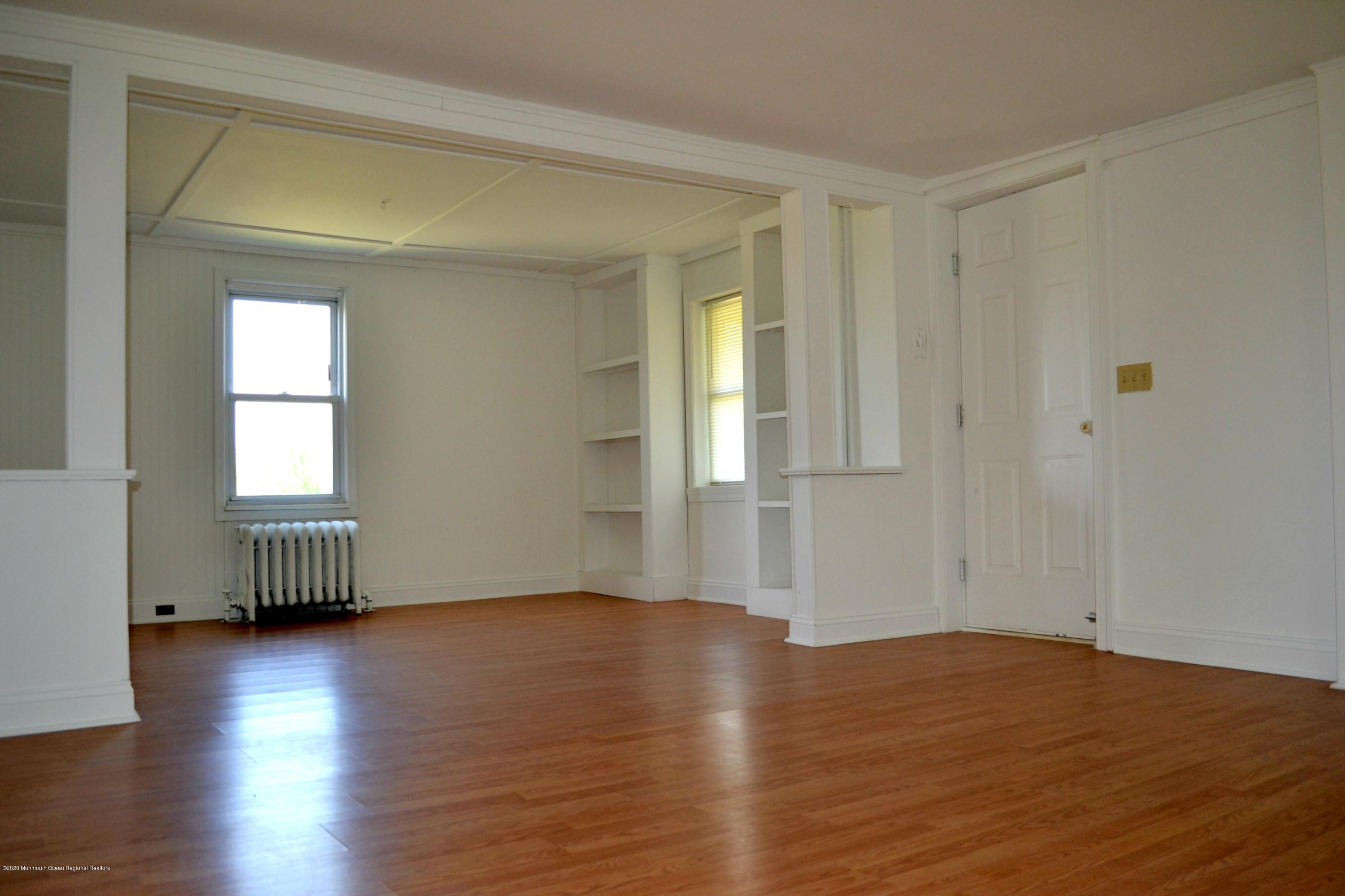 1167 Hedding Road Columbus, NJ 08022 - Photo 5 of 16 an empty room with wooden floor and windows