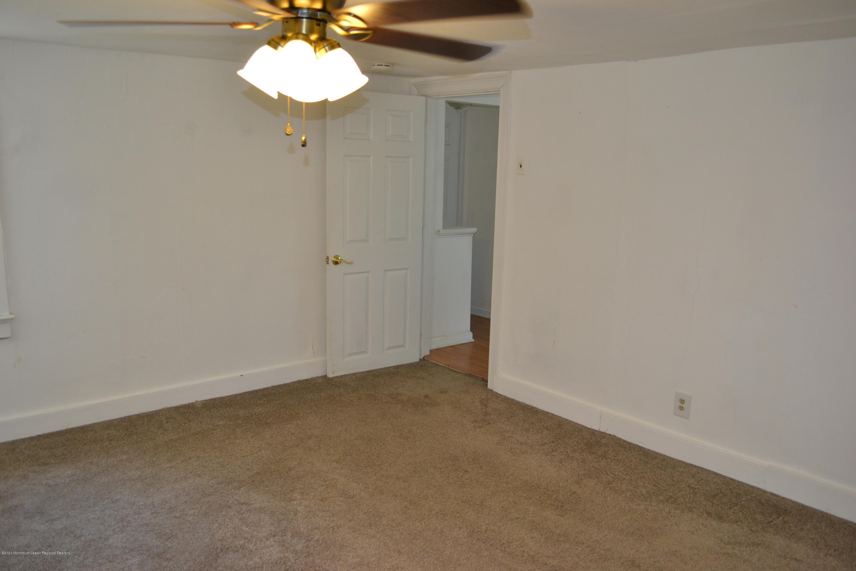 1167 Hedding Road Columbus, NJ 08022 - Photo 8 of 16 an empty room with a chandelier fan and a window