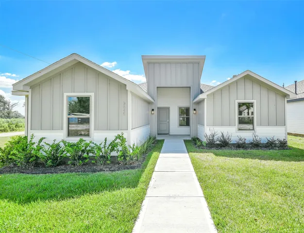 a front view of a house with a yard and porch