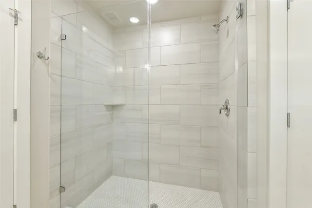 a spacious bathroom with a shower sink and mirror