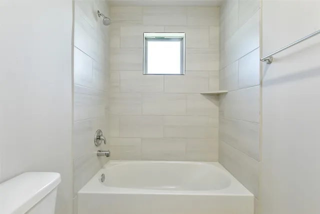 a white bath tub sitting next to a white toilet