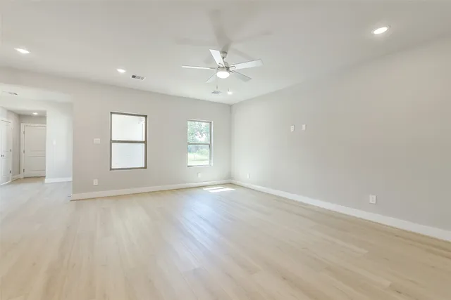 wooden floor in an empty room with a window