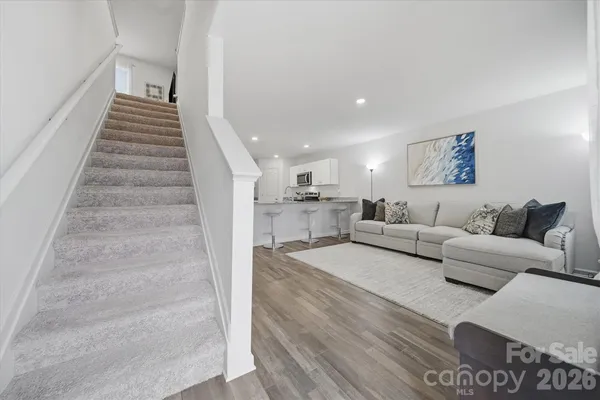 a living room with furniture and a stair