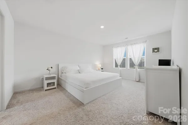 a large white bed in a white room