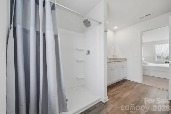 a bathroom with a shower and a sink