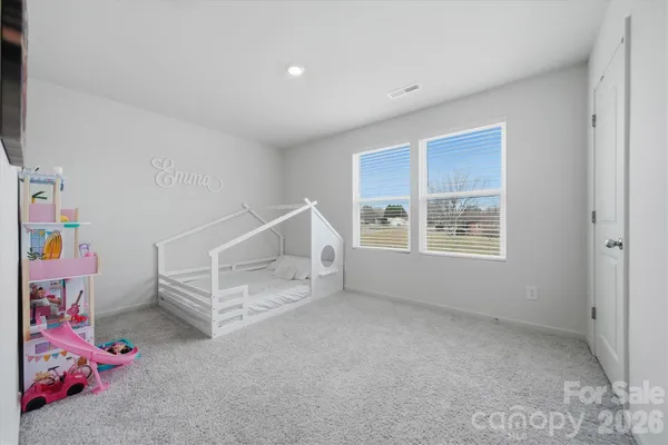 an empty room with a window and stairs