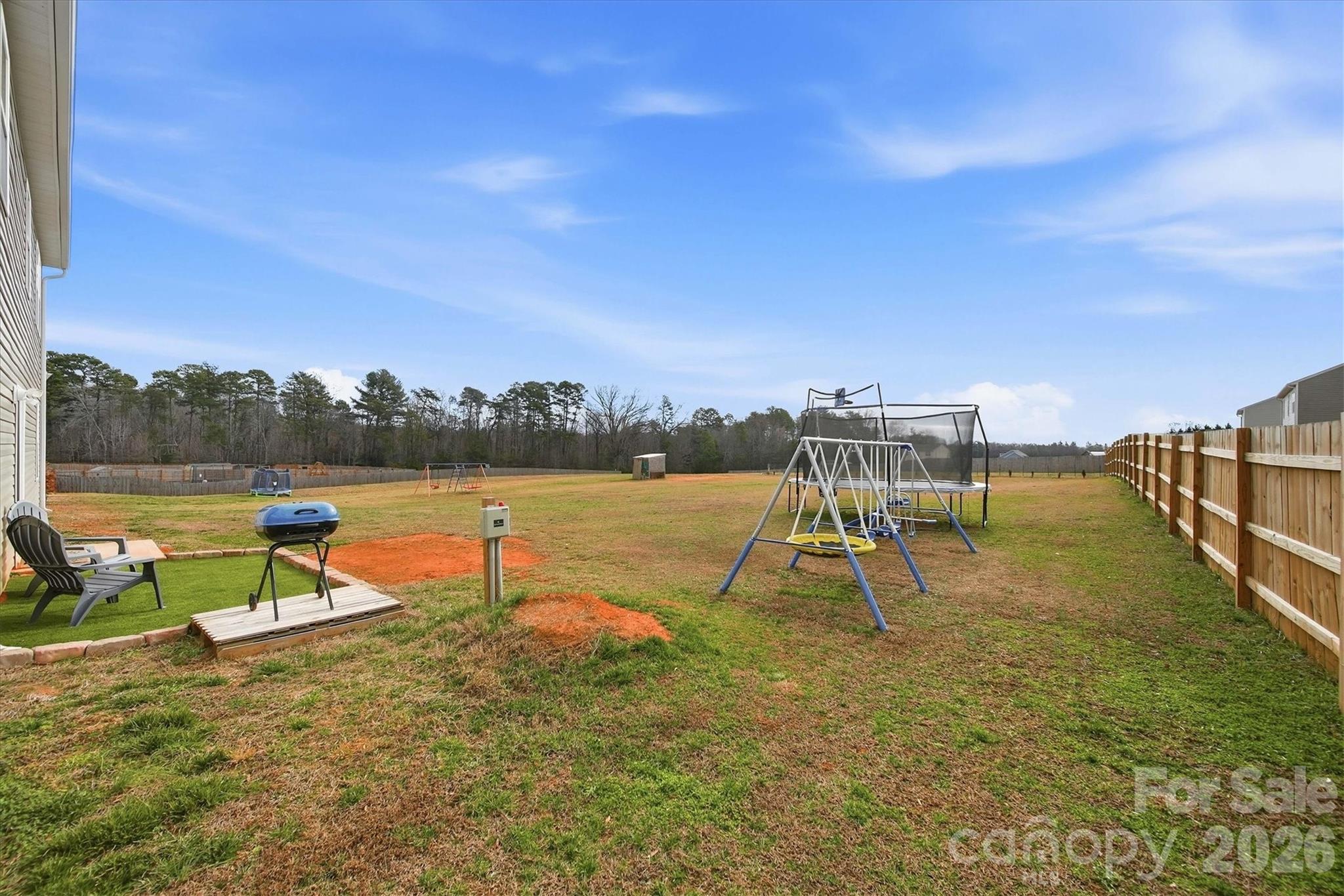 4484 Springs Road Conover, NC 28613 - Photo 24 of 32 a view of a lake with a yard and a bench