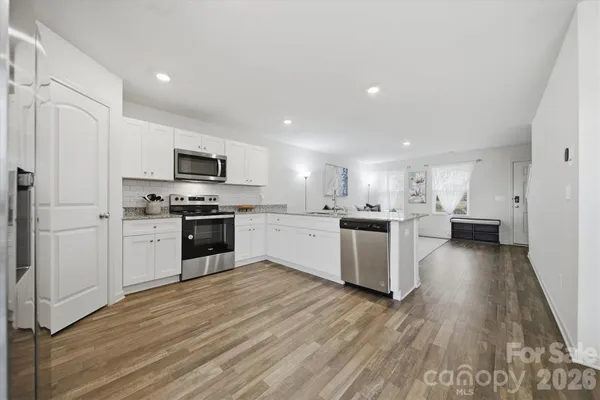 a kitchen with a white cabinets and stainless steel appliances