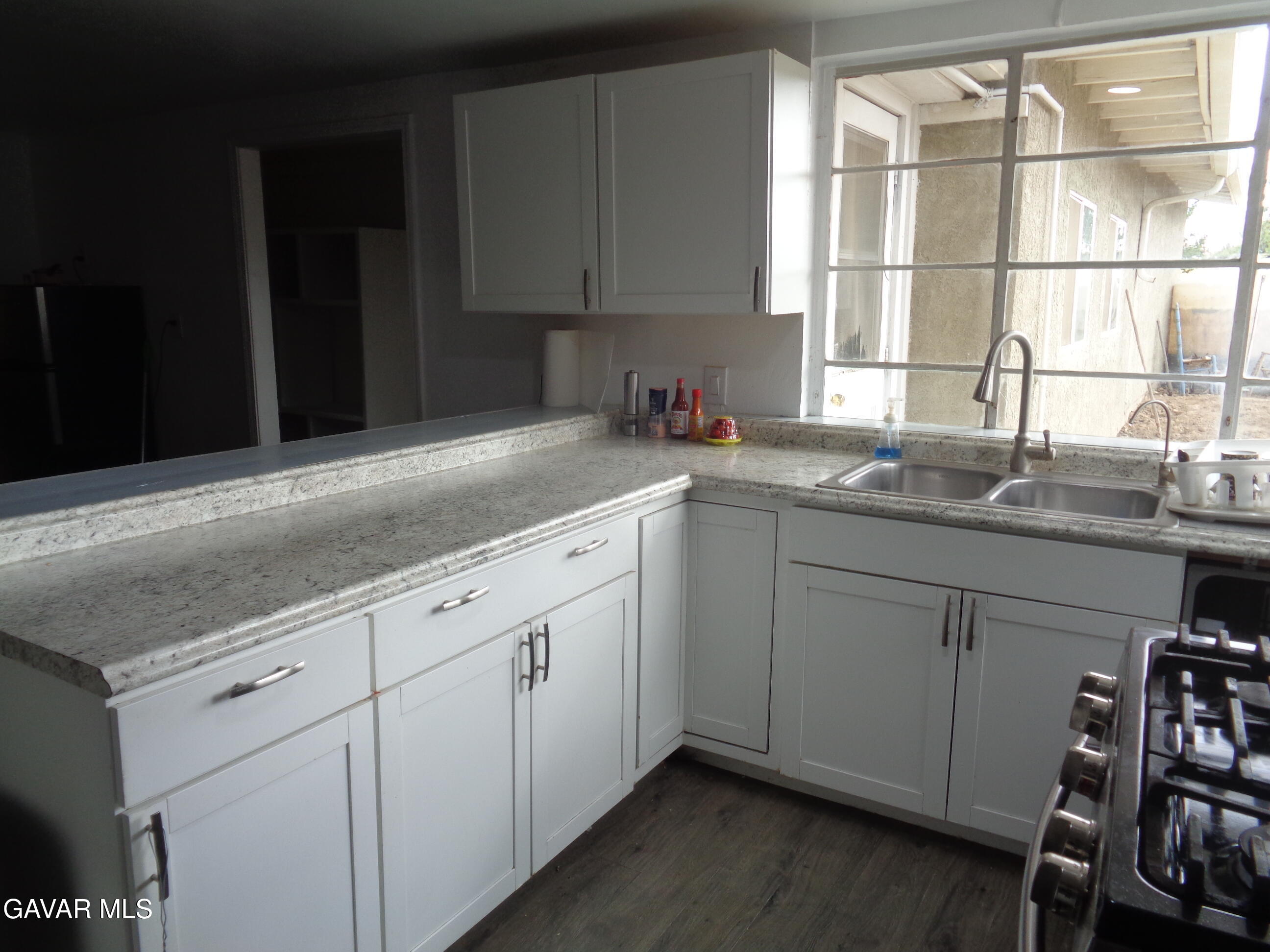 9728 Aveune S10 Street East Littlerock, CA 93543 - Photo 2 of 45 a kitchen with a sink and cabinets