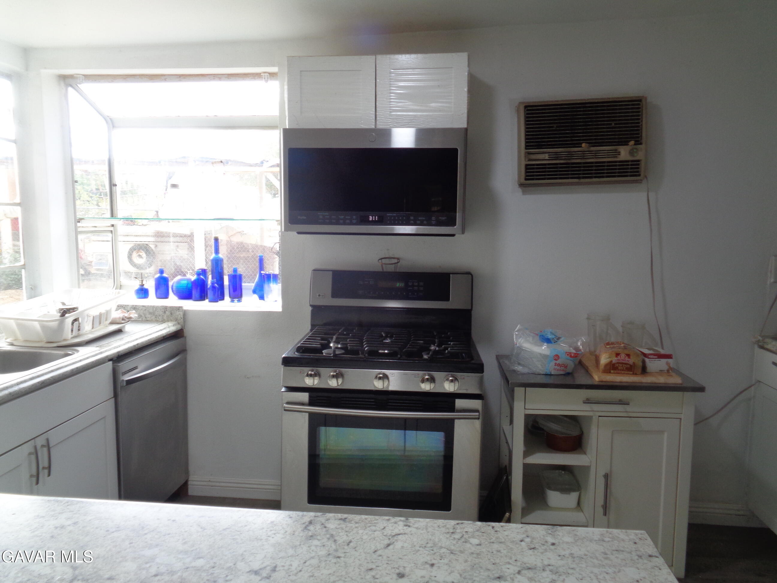 9728 Aveune S10 Street East Littlerock, CA 93543 - Photo 3 of 45 a kitchen with stainless steel appliances a stove and a microwave