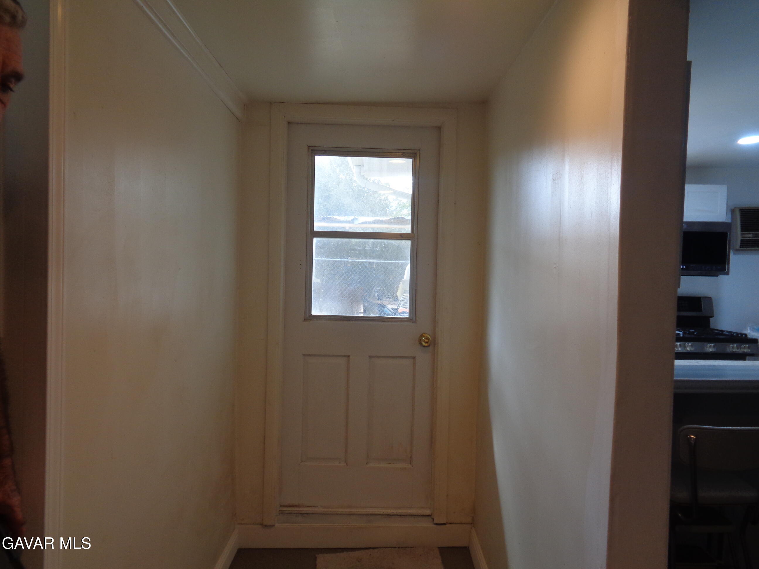 9728 Aveune S10 Street East Littlerock, CA 93543 - Photo 43 of 45 a view of an empty room with wooden floor and a window