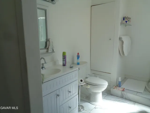 a view of walk in closet with clothes