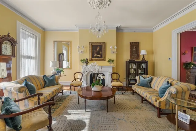 a living room with furniture or couch and a chandelier