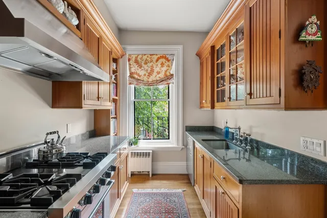 a kitchen with granite countertop a stove a sink and a granite counter tops