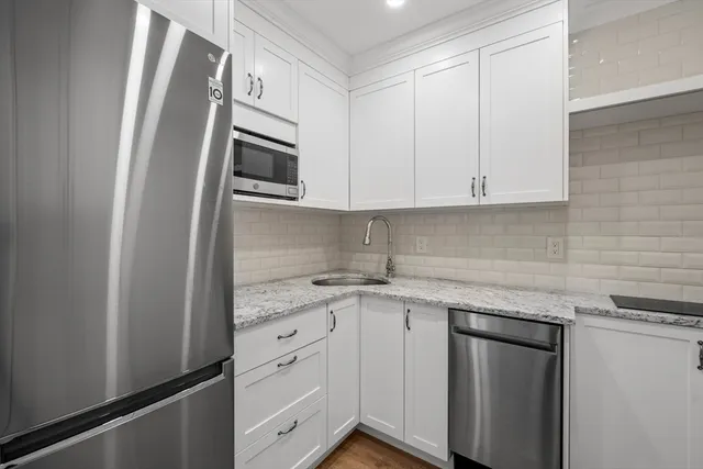 a kitchen with stainless steel appliances granite countertop a refrigerator sink and cabinets