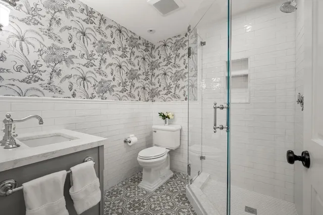 a bathroom with a sink toilet and shower