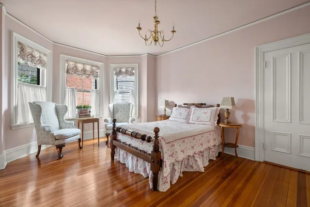 a bedroom with a bed and a chandelier