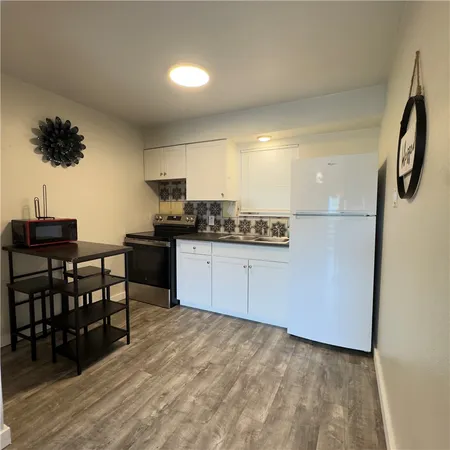a kitchen with stainless steel appliances a refrigerator and a sink