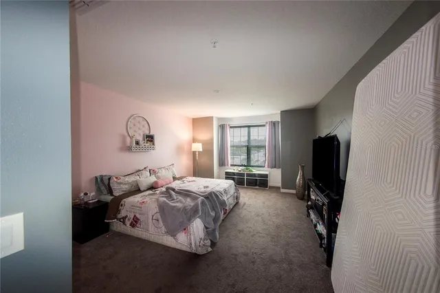 a bedroom with bed and a window