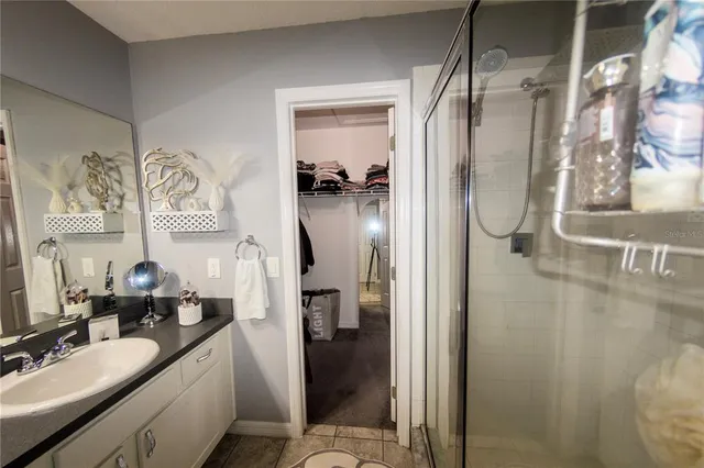 a bedroom with a bed and a flat tv screen on dresser