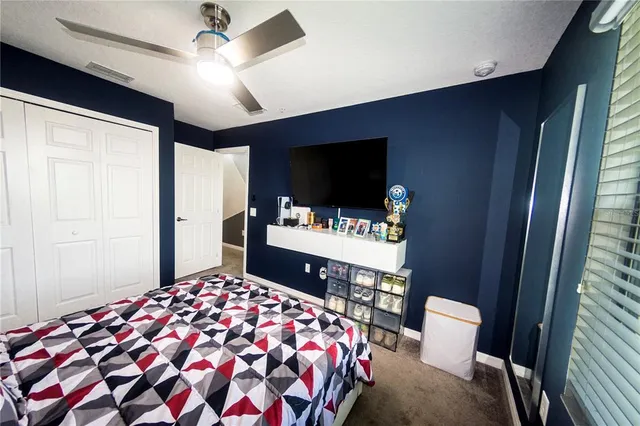 a bedroom with a bed and dresser