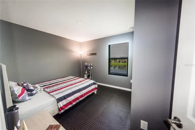 a bedroom with a bed and a chandelier