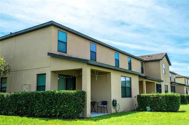 a front view of a house with yard and green space