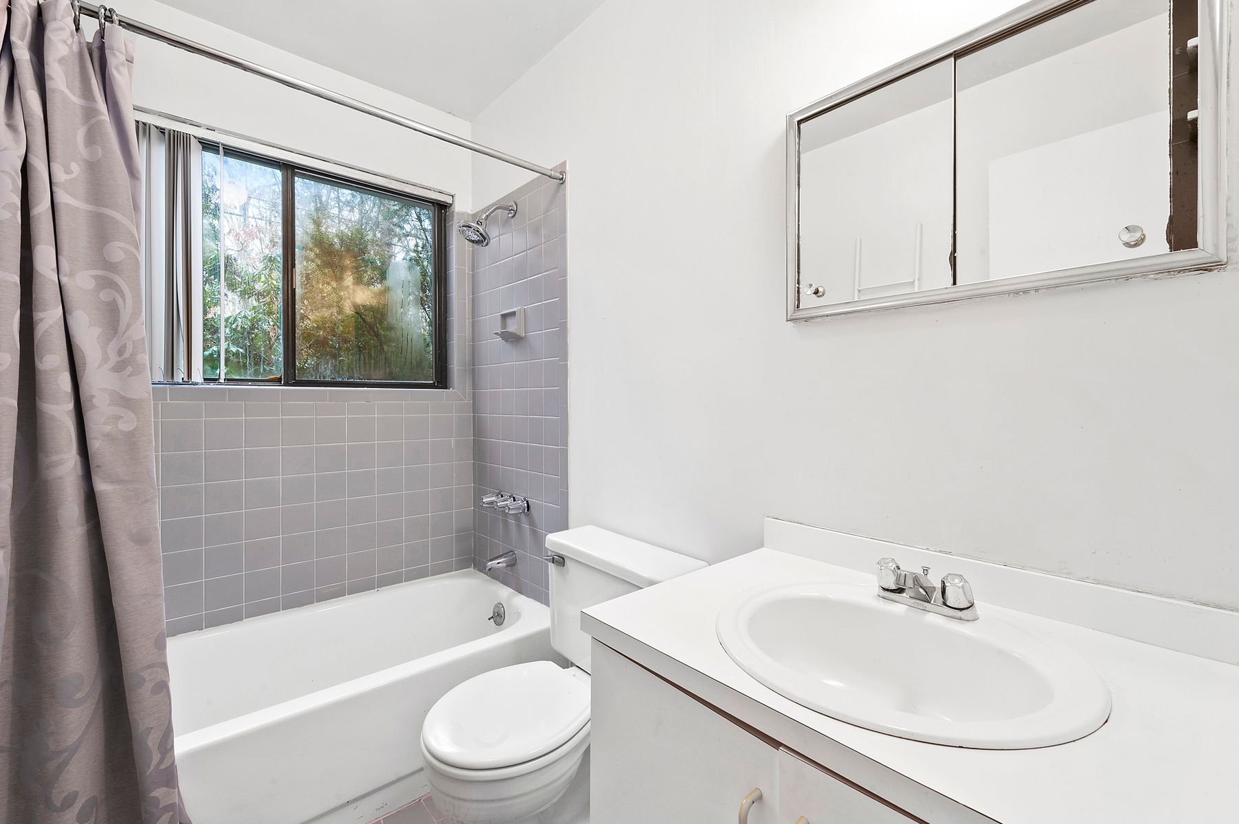 141 Roses Grove Road Southampton, NY 11968 - Photo 7 of 9 a bathroom with a sink a toilet and bathtub