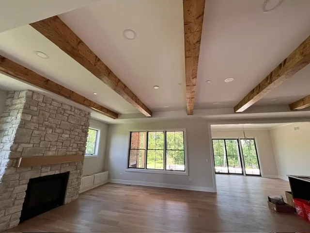 a view of an empty room with a fireplace and a window