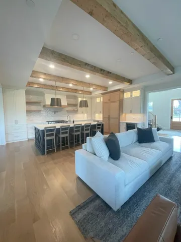 a living room with furniture and kitchen view