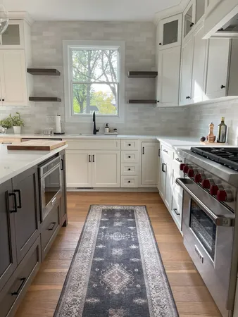 a kitchen with stainless steel appliances granite countertop a stove a sink dishwasher and cabinets with wooden floor