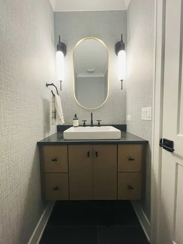 a bathroom with a sink vanity and mirror