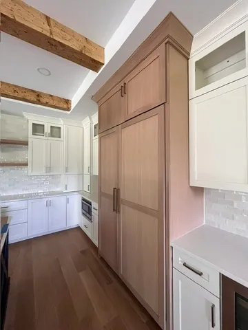 a kitchen with granite countertop a refrigerator and a sink